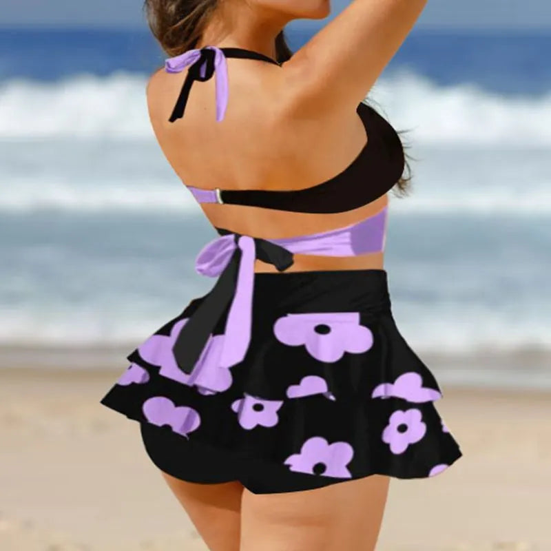 Women's purple high-waisted bikini swimsuit with lace-up detail and skirt