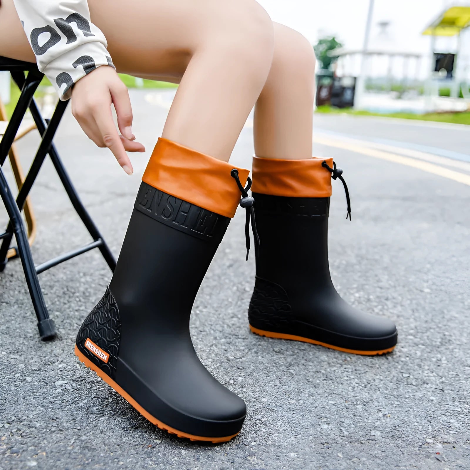 Women's solid colour PVC rain boots with non-slip sole in apricot, black, brown, or pink waterproof mouth.