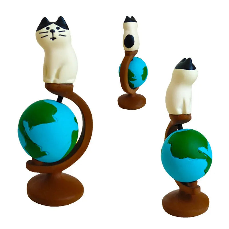 Cartoon resin figurine of a Statue of Liberty cat holding a globe, decorative craft ornament.