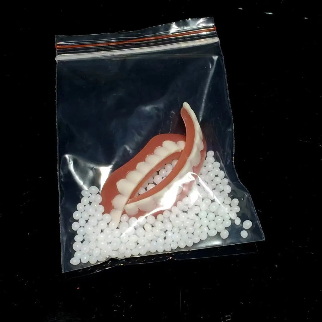Disposable silicone simulation smile dentures with upper and lower teeth in colour box packaging