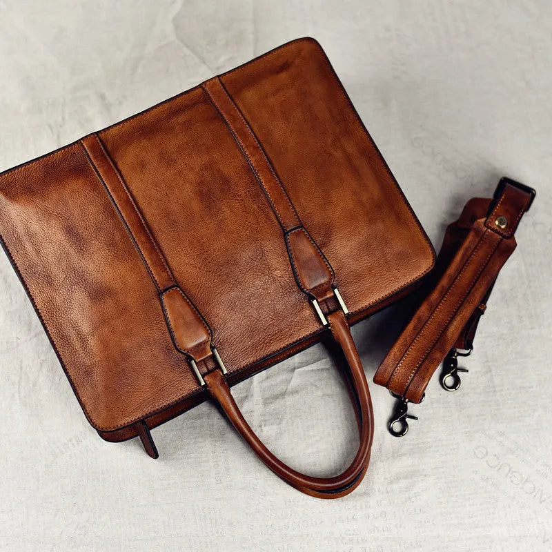 Men's brown leather horizontal business handbag with zipper closure shown from the front.