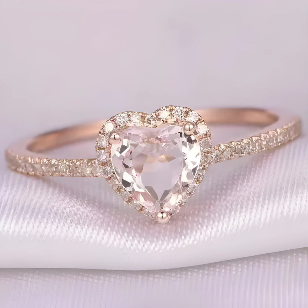 Women's heart-shaped crystal wedding ring in rose gold or silver on a white background.