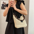 Knitted tote beach bag showing bucket shape, contrast stitching, and crossbody strap