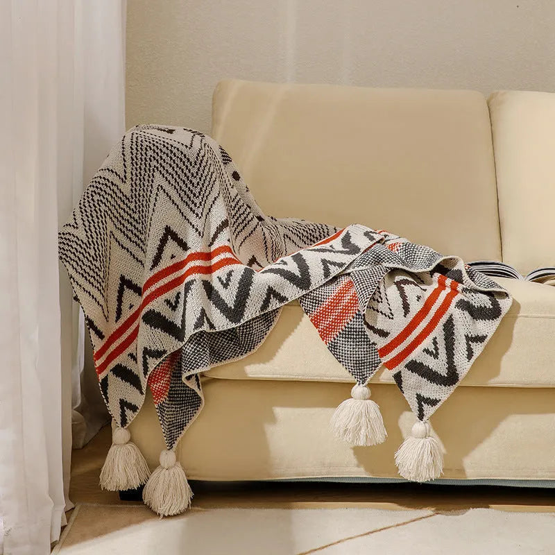 Bohemian-style acrylic sofa cover blanket with tassel trim in a geometric pattern colour option