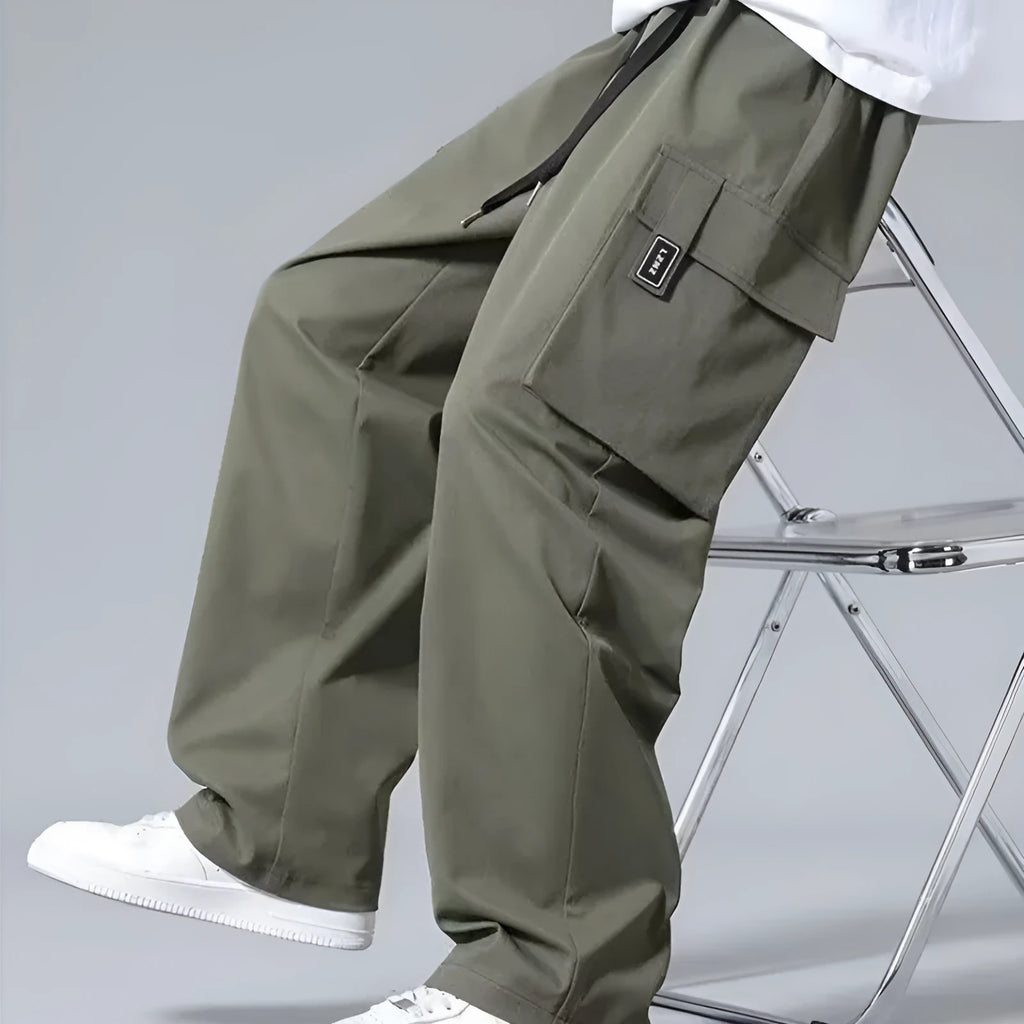 Boys in army green straight leg cargo pants with large pockets and a drawstring waist.