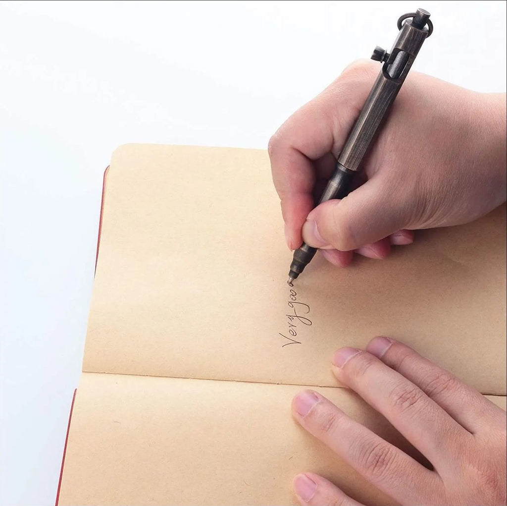 Brass machine gun tactical pen with hexagonal bolt design showing brass natural colour finish