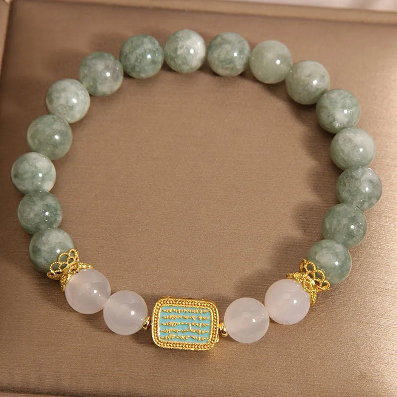 Oil green emerald crystal bracelet with five engraved Buddhist scripture beads on female wrist