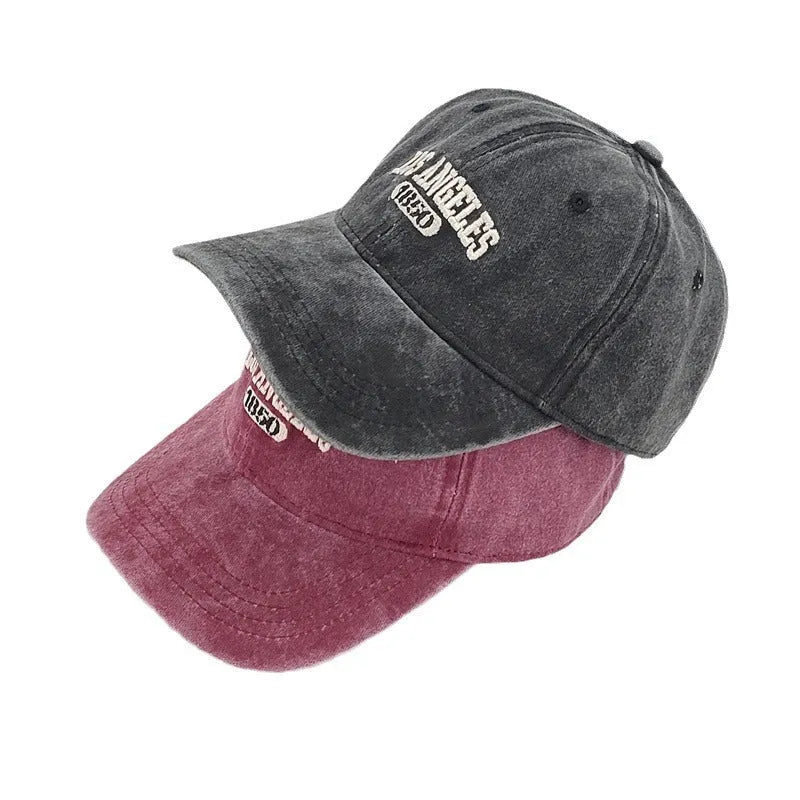 Personalised washed distressed embroidered peaked cap in acrylic fabric on adjustable head model.
