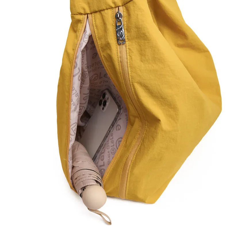 Soft heart-shaped nylon underarm bag for women in black, shown with a crossbody strap.