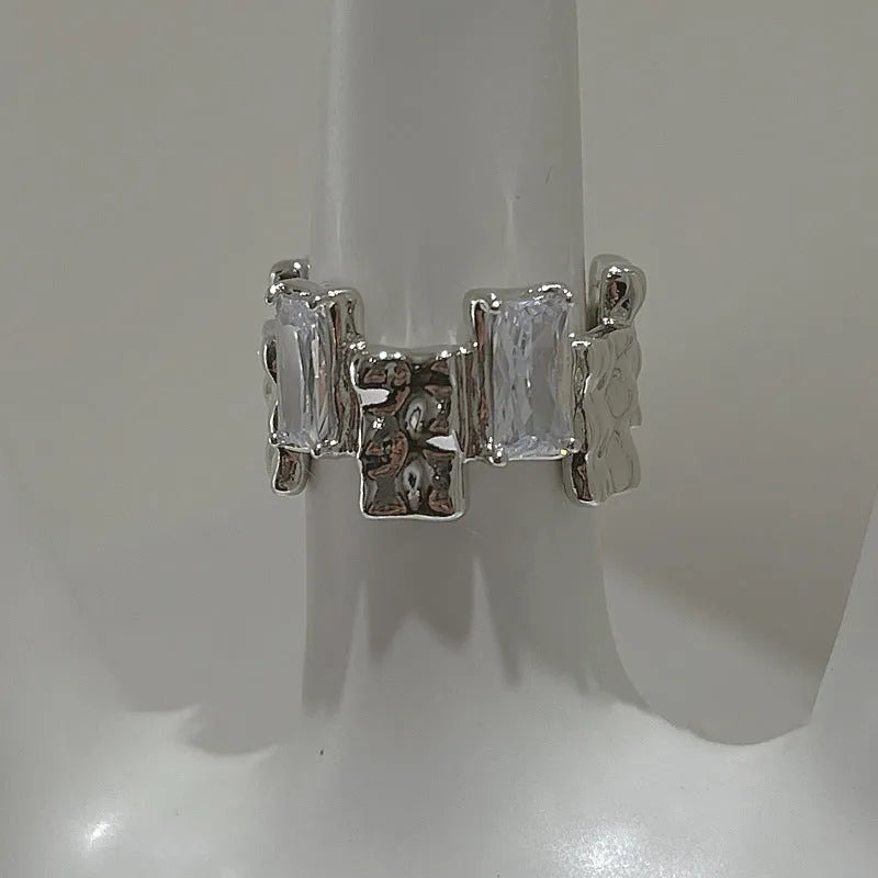 Silver plated open ring with geometric cross zircon and retro design.