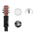 Black automatic guitar chord capo device on guitar neck for beginner practice