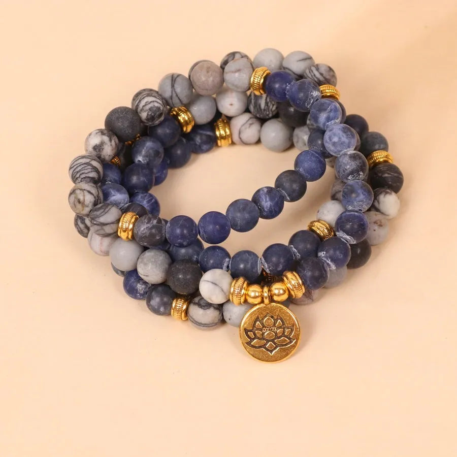 Blue multi layer bracelet with patterned network stone beads and alloy construction