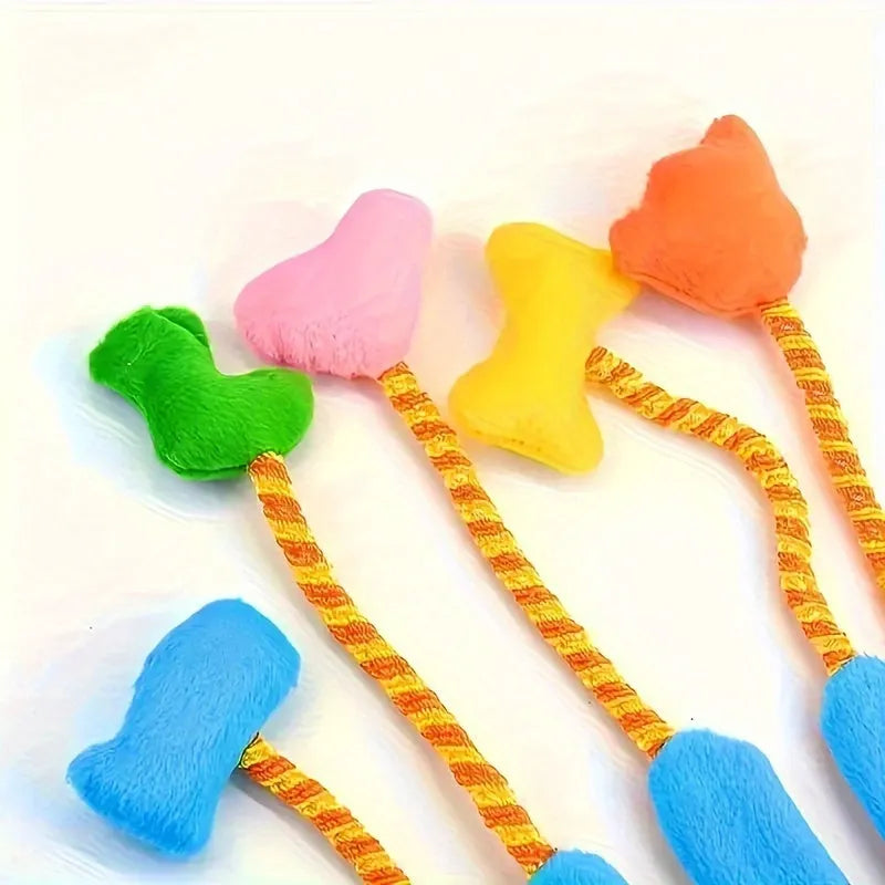 Yellow and blue interactive cat toy glove with plush trailer and bell.