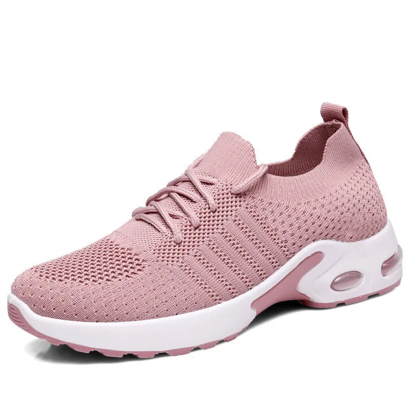 Women's solid colour mesh sneaker with round toe and white PVC sole on a grey background