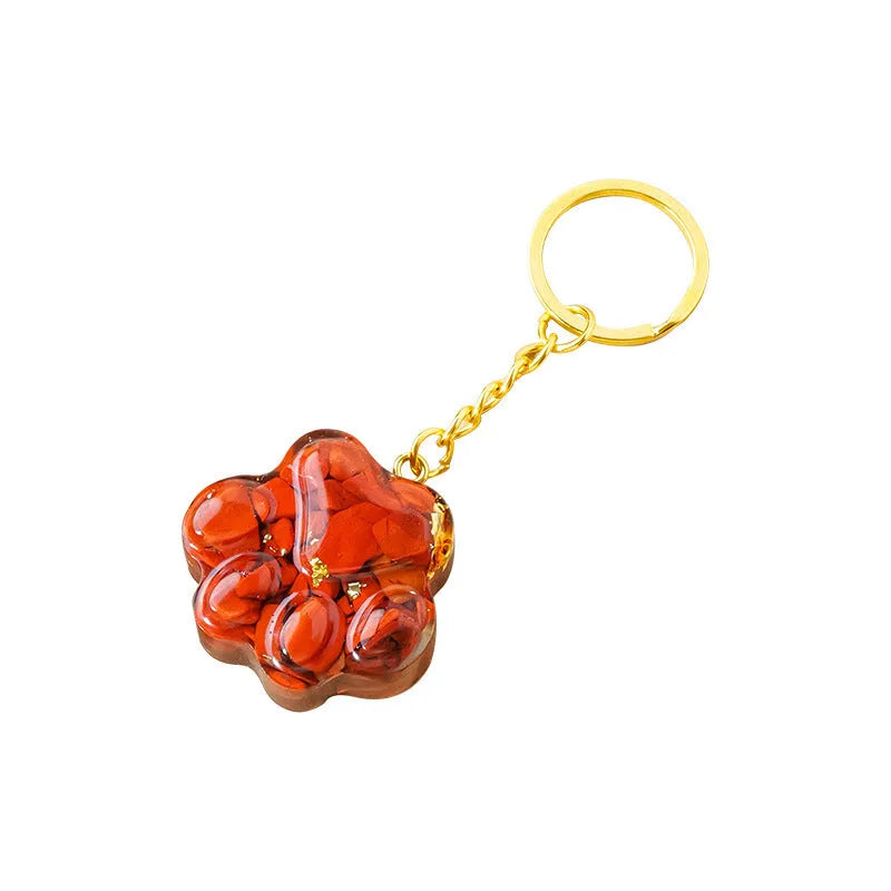 Cat's paw shaped keychain pendant made from a natural crystal gemstone on a keyring.