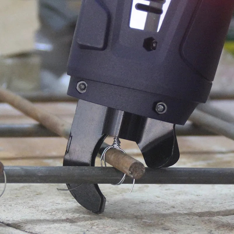 Electric steel rebar tying machine with battery and charger on a construction site