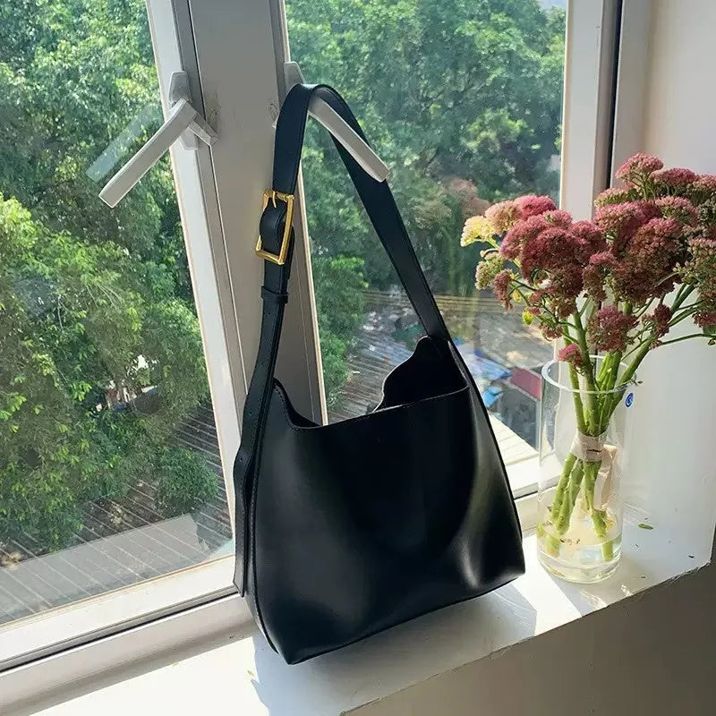 Women's soft PU shoulder bag with swing threads decoration in black and brown colour options