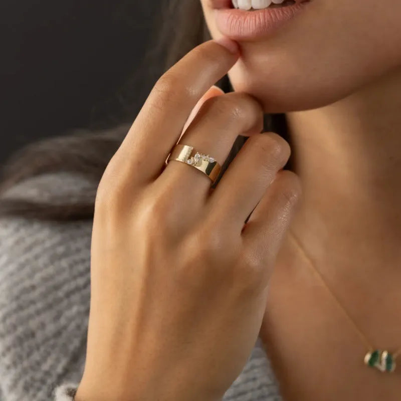 Gold-colour women's ring with zircon detailing showing electroplated finish and sizing options