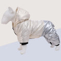Green waterproof cotton-padded dog coat with four-legged design on medium-sized dog outdoors