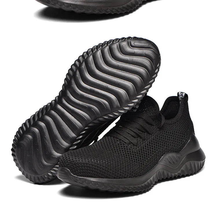 Black work safety shoe with steel toe cap and EVA sole on a grey background