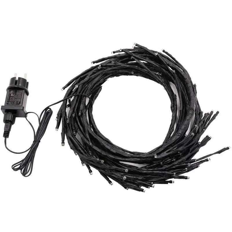 Flexible DIY LED willow vine garland light with warm white LEDs bent into a decorative shape.
