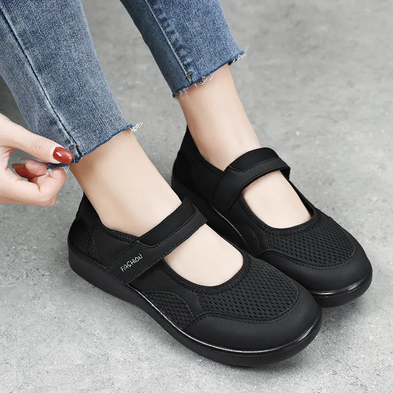 Women's low-top cloth shoes with mesh upper and Velcro strap in grey.
