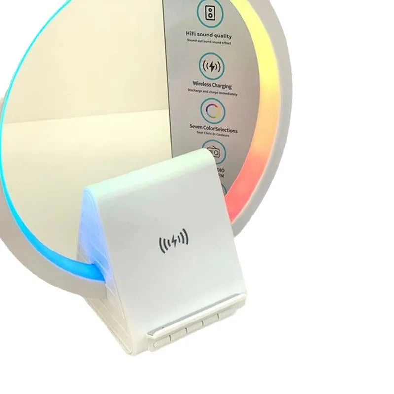 White portable Bluetooth speaker with integrated wireless charging pad and ambient lighting.