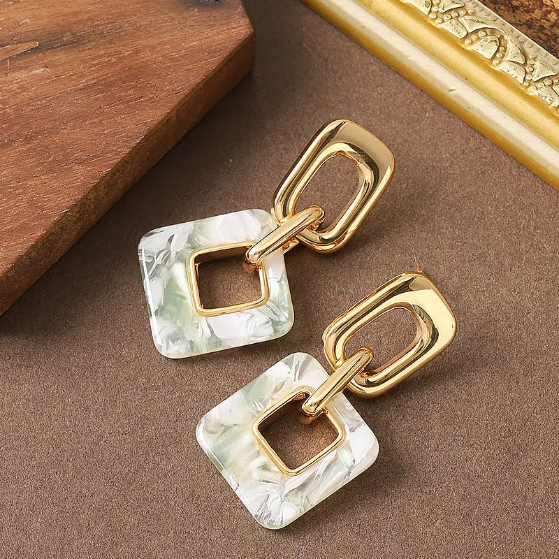 Copper geometric square earrings with hollow design and chamfered corners in metallic finish