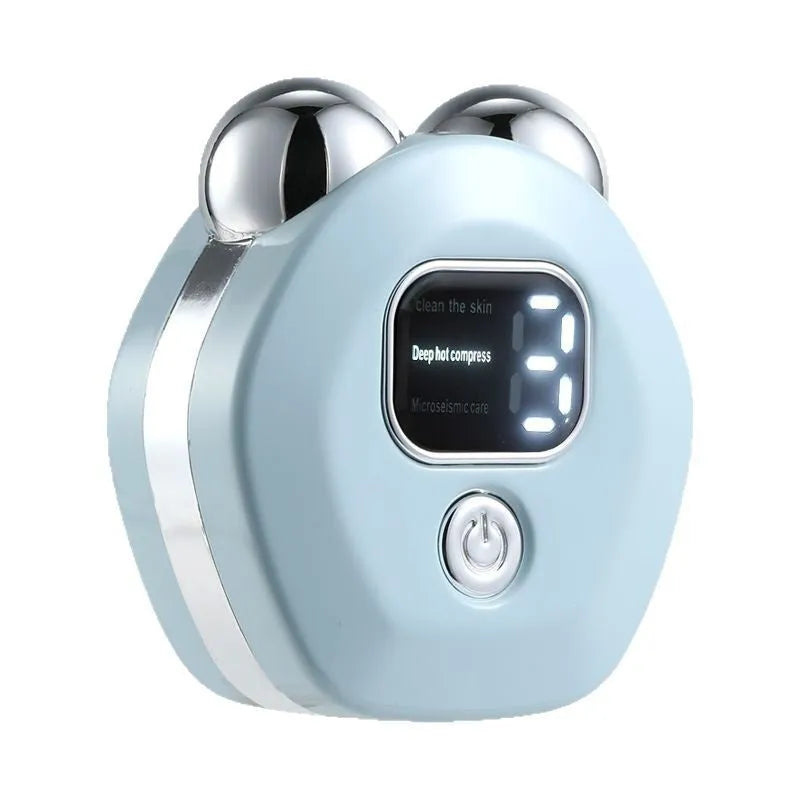 Portable white hot compress and micro current facial massage instrument with double rollers on a table.