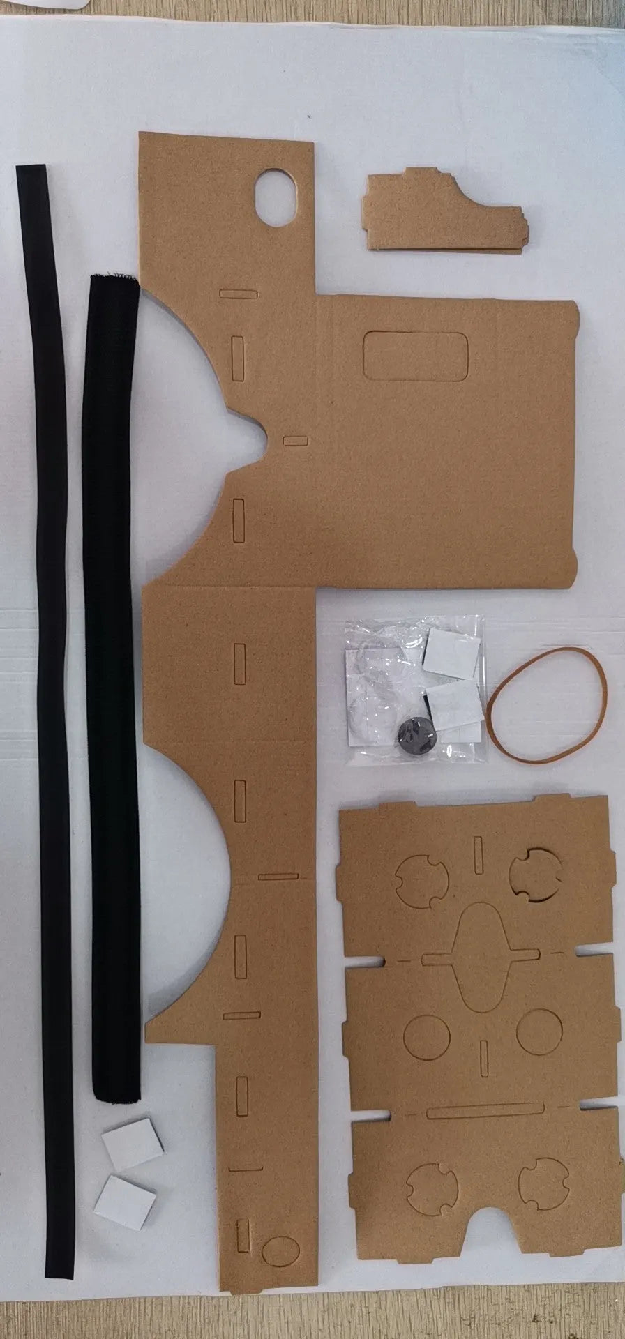 Pink and white VR cardboard glasses for smartphones with adjustable head strap.
