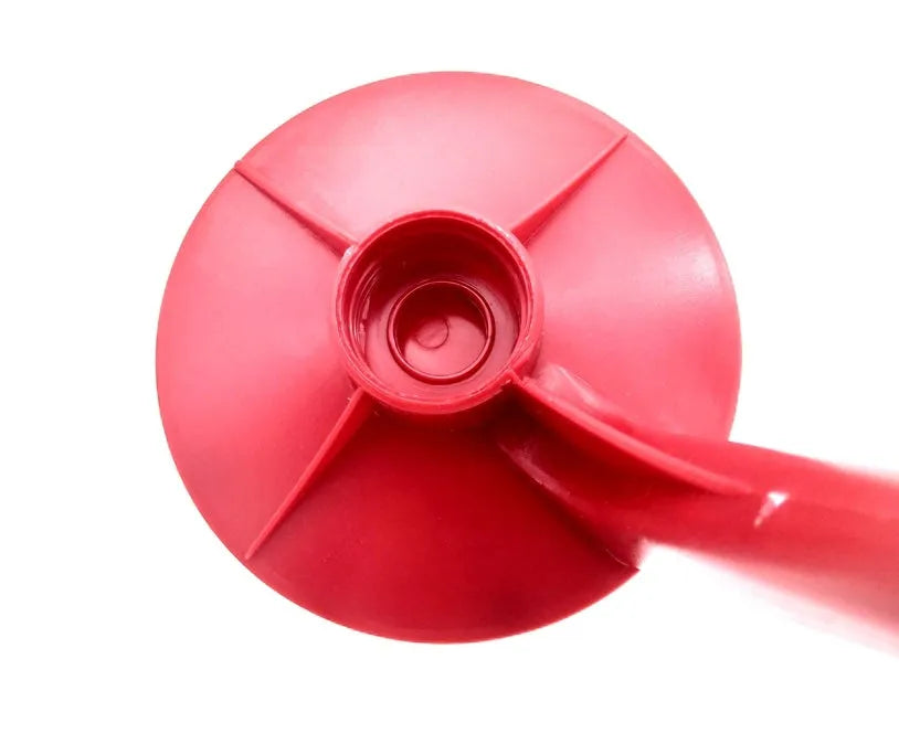 Red plastic soda dispenser attached to 2-litre bottle showing push-button mechanism
