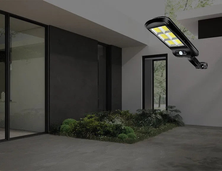Black solar-powered motion sensor street light for outdoor garden and driveway security lighting