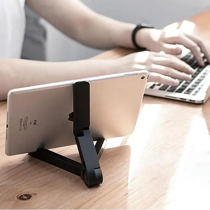Black foldable tablet holder supporting a smartphone in landscape mode on a desk