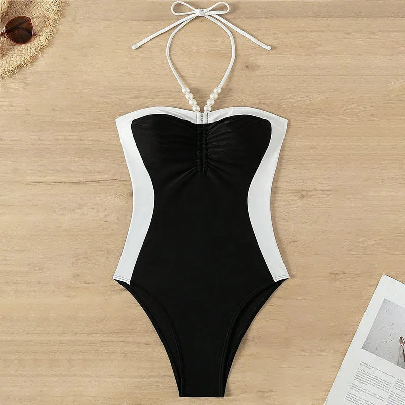 Black and white women's one-piece swimsuit with pearl spaghetti straps, sleeveless design
