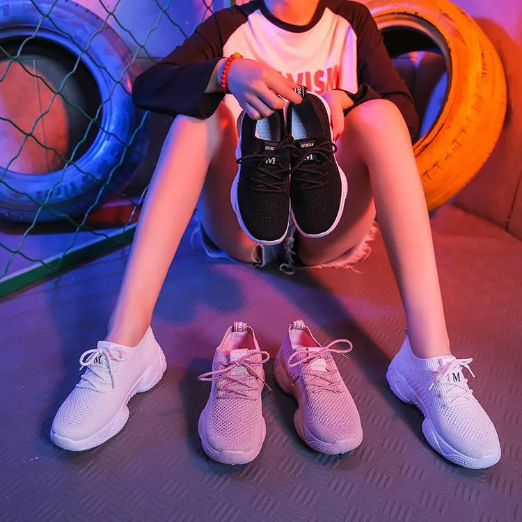 White women's low-top woven sports shoes with thick rubber sole and front strap closure.