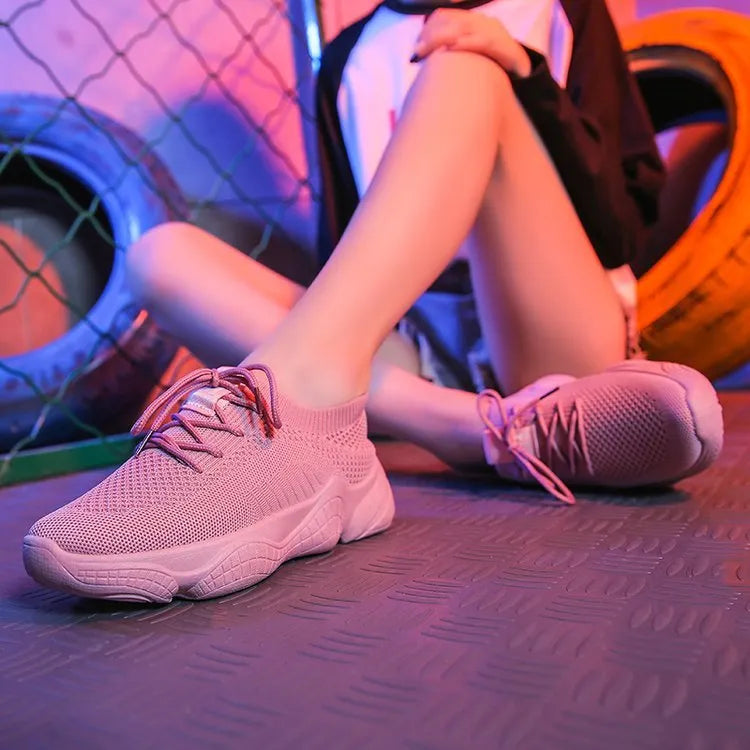 White women's low-top woven sports shoes with thick rubber sole and front strap closure.