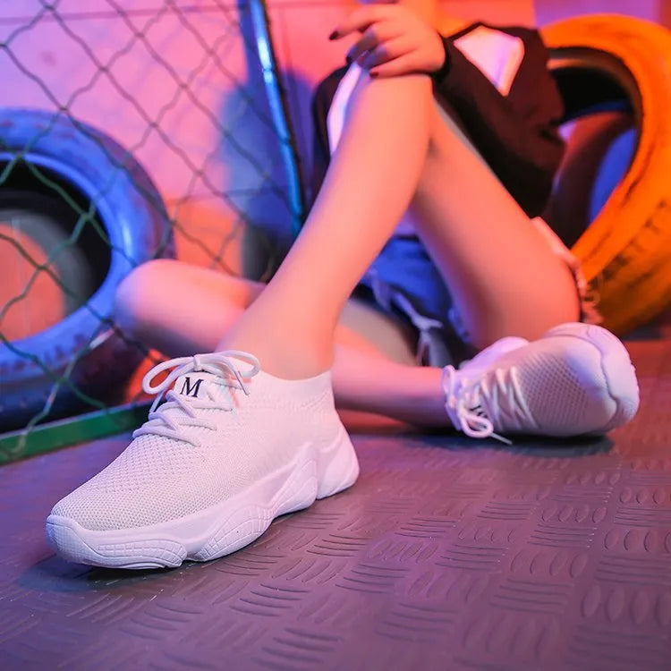 White women's low-top woven sports shoes with thick rubber sole and front strap closure.