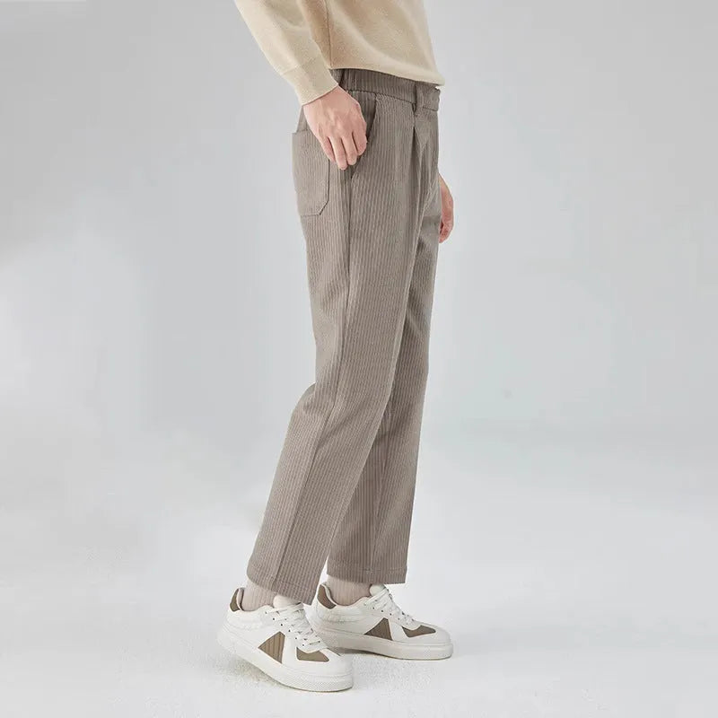 Men's straight-leg corduroy trousers in beige, showing loose fit and textured fabric