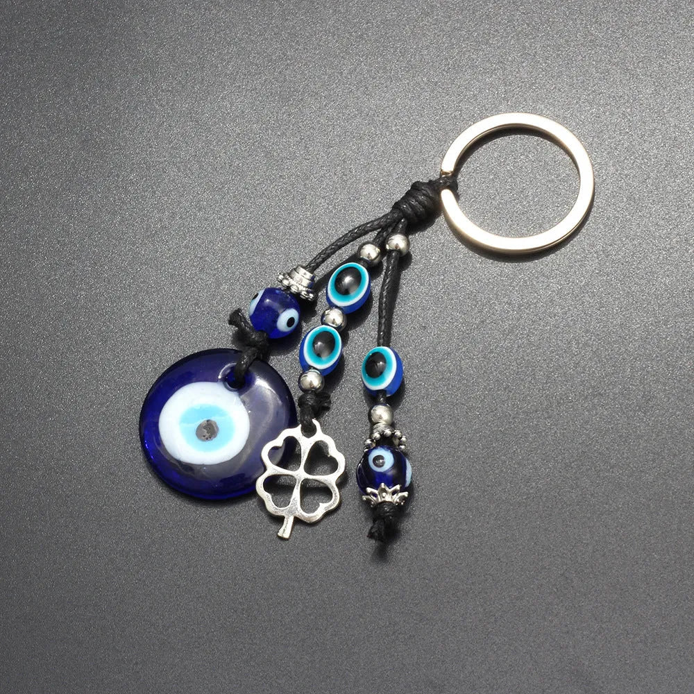 Blue evil eye keychain with metal plant-shaped pendant and unisex keyring design