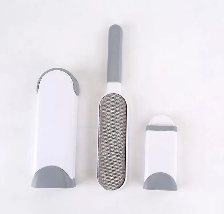 Blue reusable pet hair removal brush with self-cleaning base on a grey sofa.