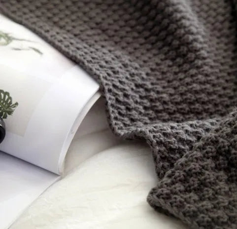 Nordic style fringed knit ball acrylic throw blanket in beige, laid flat showing 130x170cm size.