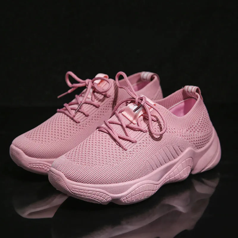 White women's low-top woven sports shoes with thick rubber sole and front strap closure.