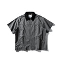 Man's loose-fitting khaki cotton overalls shirt with short sleeves, cardigan style