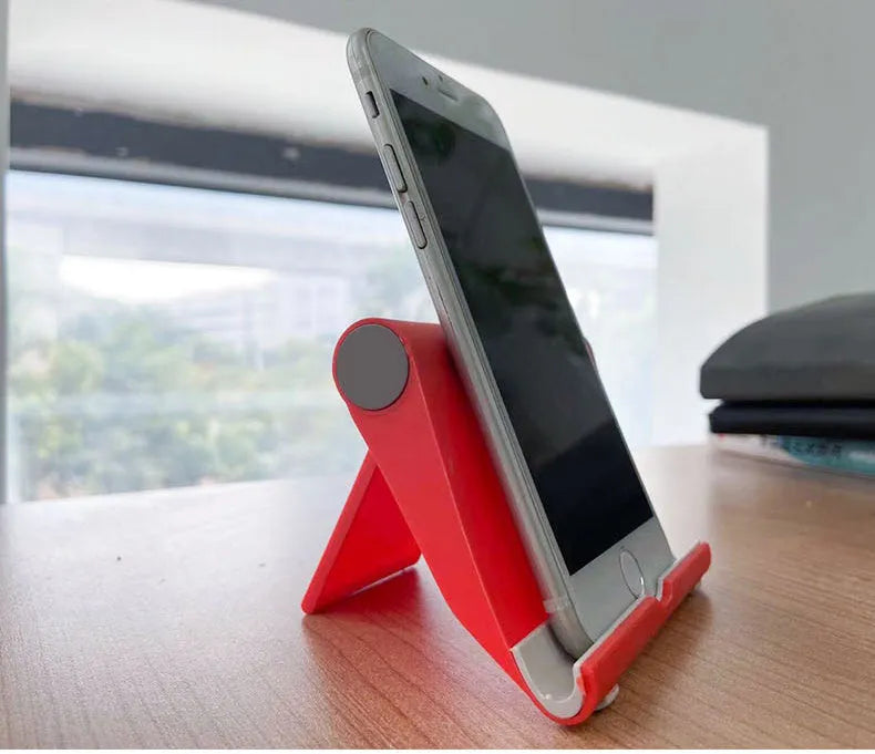 Black PE folding phone and tablet stand on a desktop, adjusted to a viewing angle.