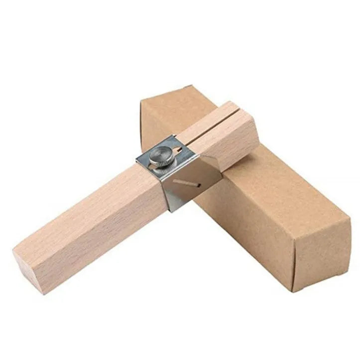 Plastic bottle cutter in log colour on a table showing its compact 2.2cm width and 14cm length