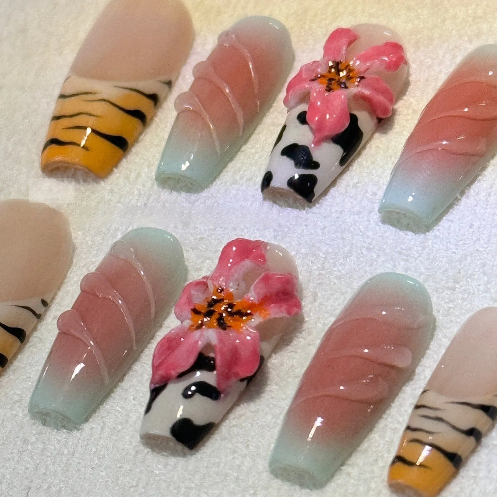 Hand-carved zebra pattern lily nail art set showing floral, leopard print and embossed designs in multiple sizes