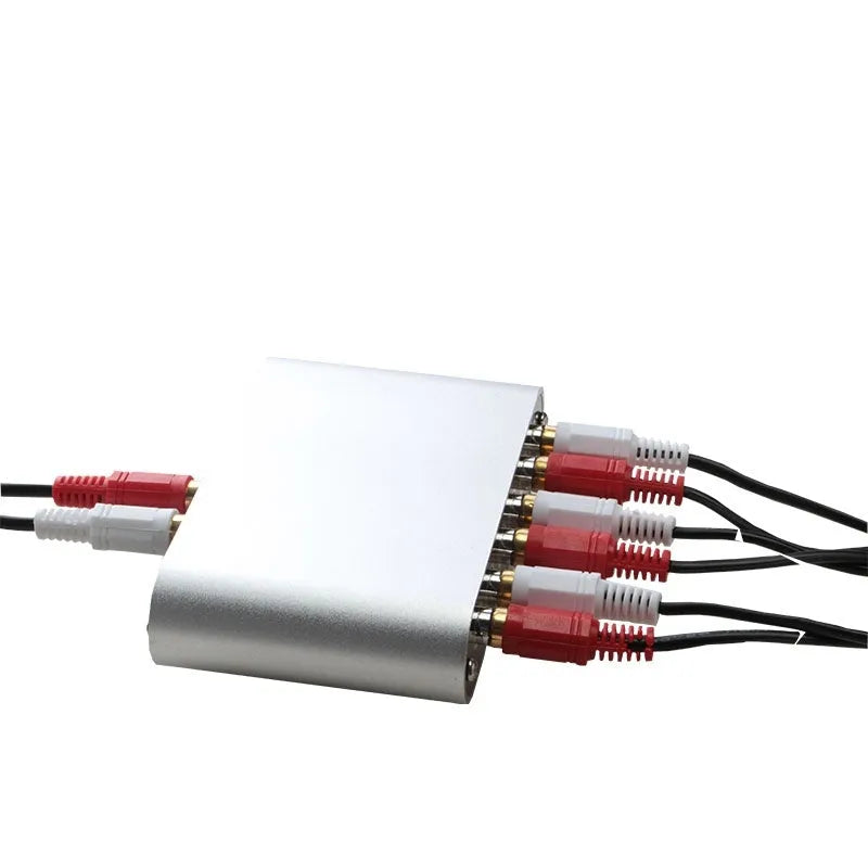 Silver aluminium audio source selector switch box with front button and infrared remote control.