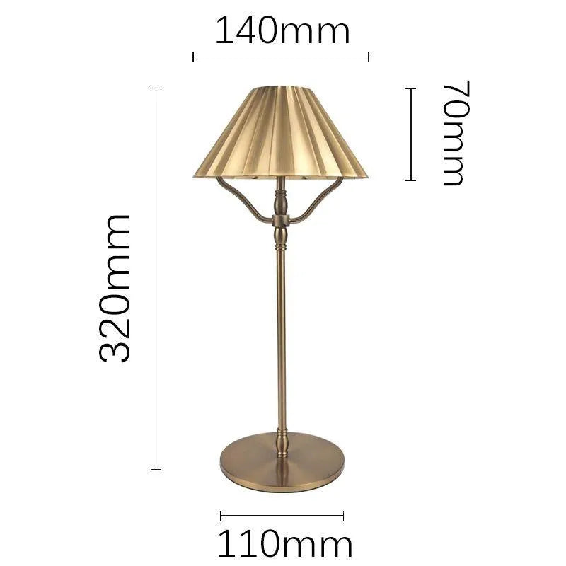 Gold alloy desk lamp with touch switch and interchangeable lampshade on a wooden desk