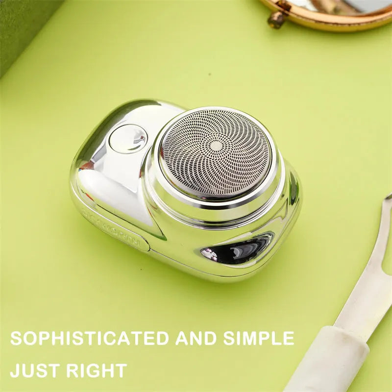 Mini portable USB electric shaver in silver with rotary head, aluminium body, and IPX7 wet and dry use