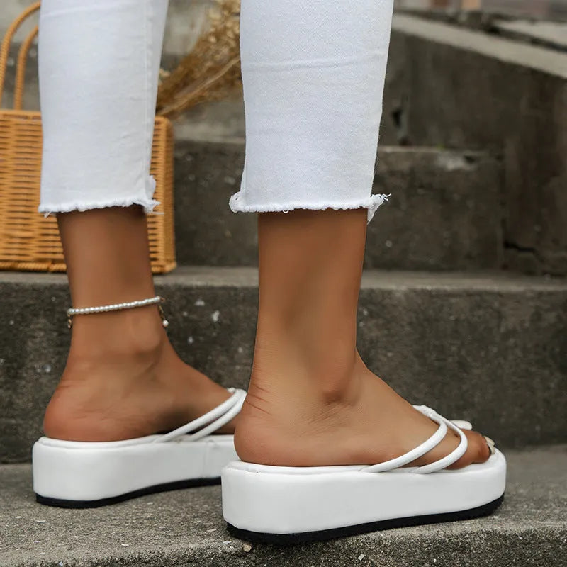 A pair of thick-soled flip-flops with a herringbone pattern PU upper in one of six available colours.